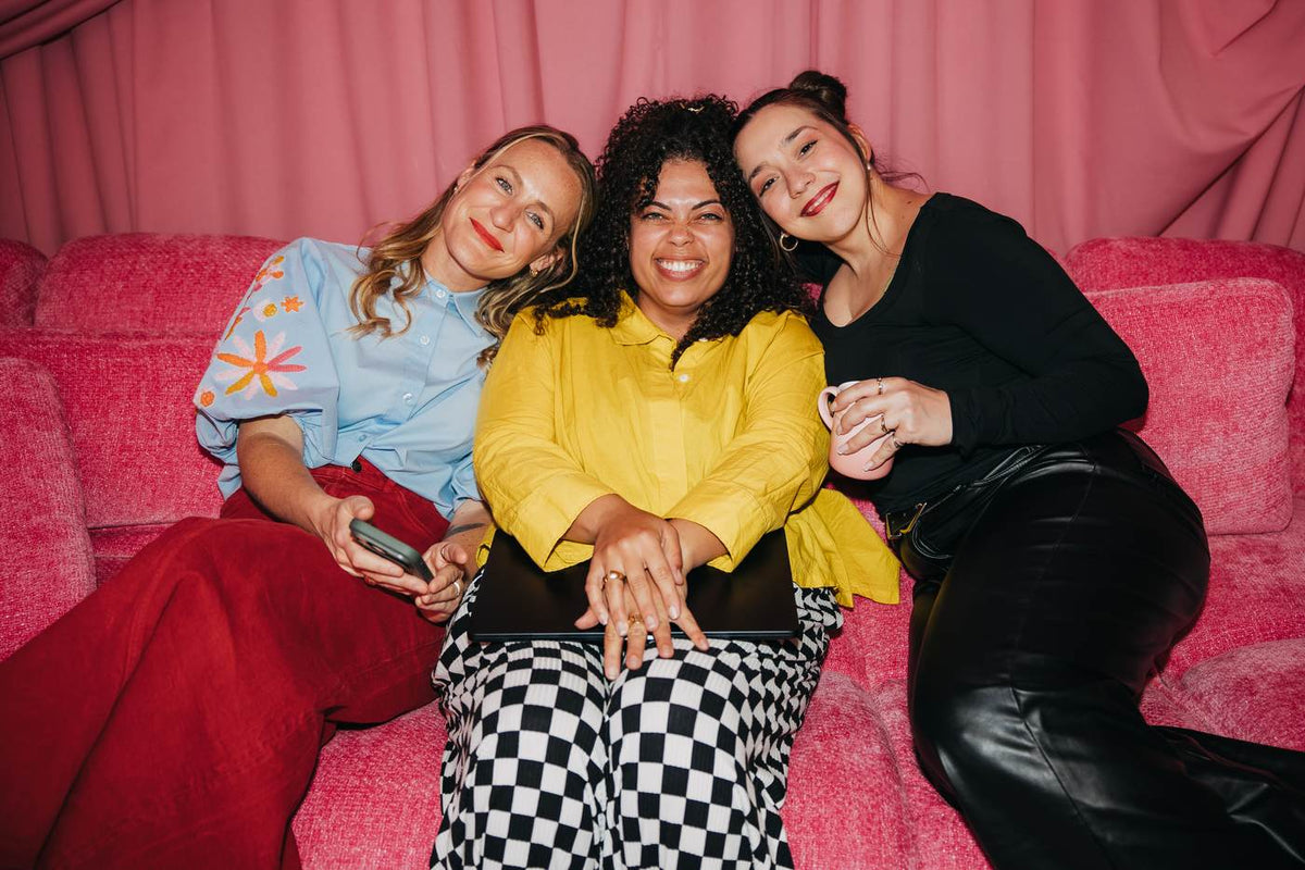 Strong Brand Social members together on the pink couch