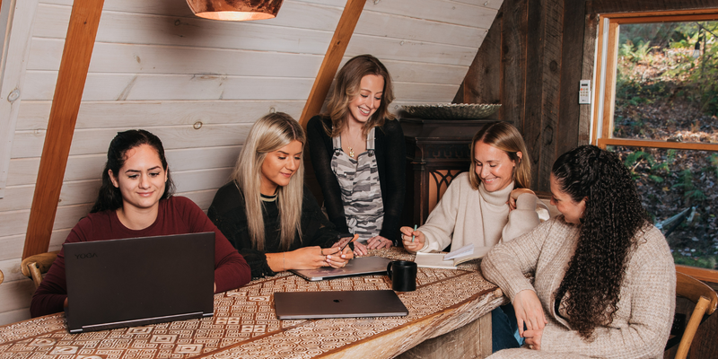 woman sitting around the table smiling and working