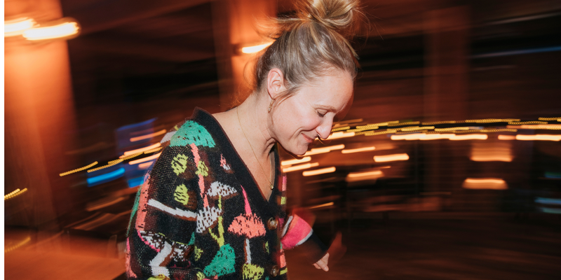 woman smiling in a colorful sweater
